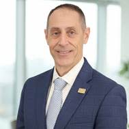 A person in a suit smiling