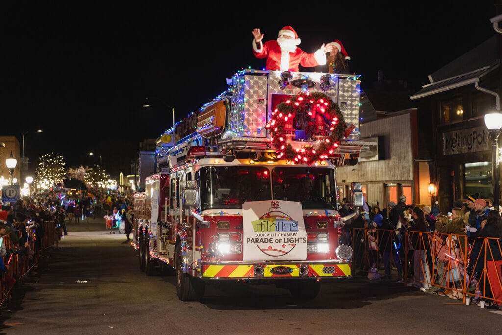 Fire truck with holiday lights and Santa Claus