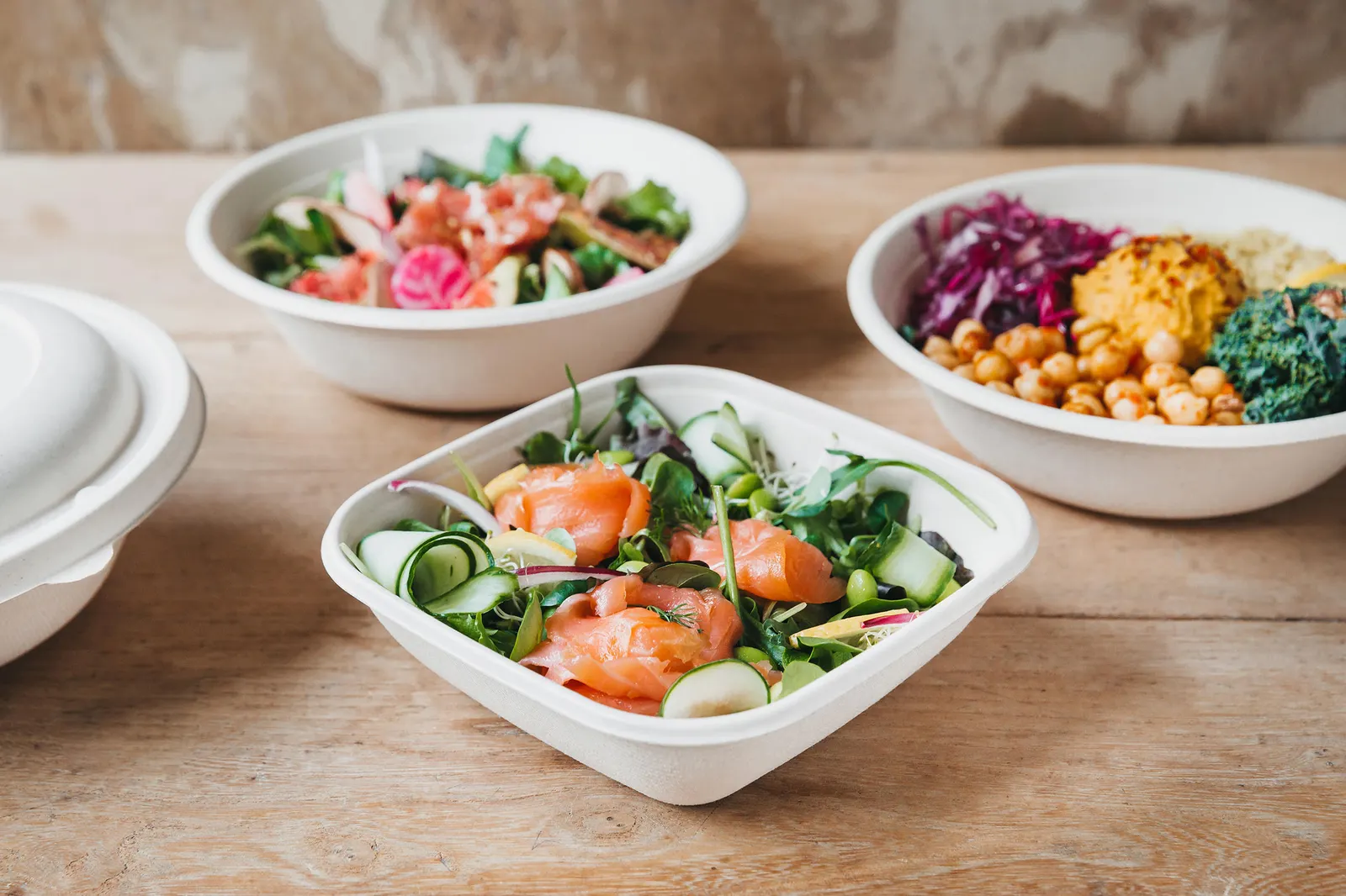 Three fiber bowls containing food.