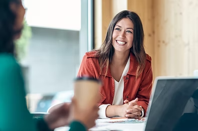 Smiling Woman talking to another woman