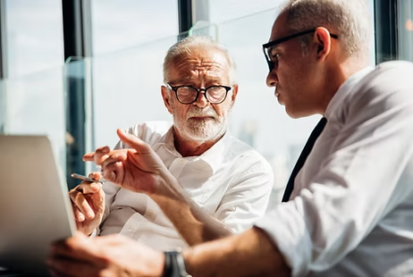 Two business men discussing project on screen