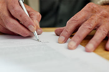 photo of hands signing something