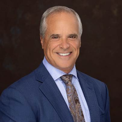 A person in a suit smiling 
AI-generated content may be incorrect.