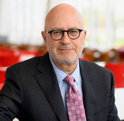 A person in a suit and tie 
AI-generated content may be incorrect.