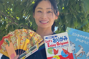 photo of lady holding up materials to learn about Japan
