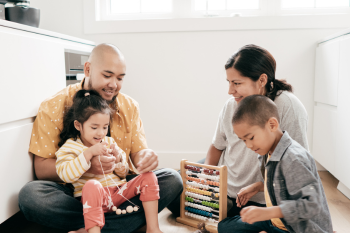 parents and children sitting together on the floor