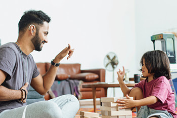Adult and child communicating via American Sign Language (ASL)