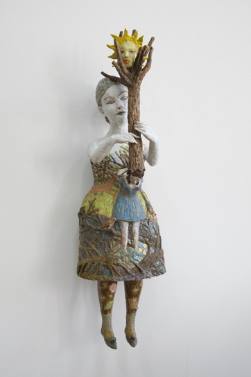 A statue of a person holding a tree 
AI-generated content may be incorrect.