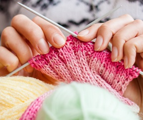 Midsection of Woman Knitting Wool