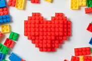 Building blocks in the shape of a heart surrounded by loose blocks