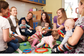 A group of babies and parents sitting in a circle