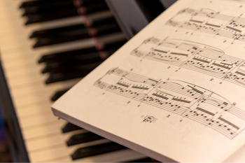 close up of sheet music on a piano