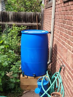 Rain barrels next to a house