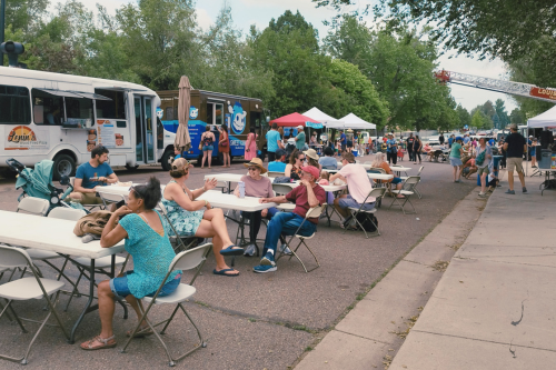 People at block party with food trucks in the background