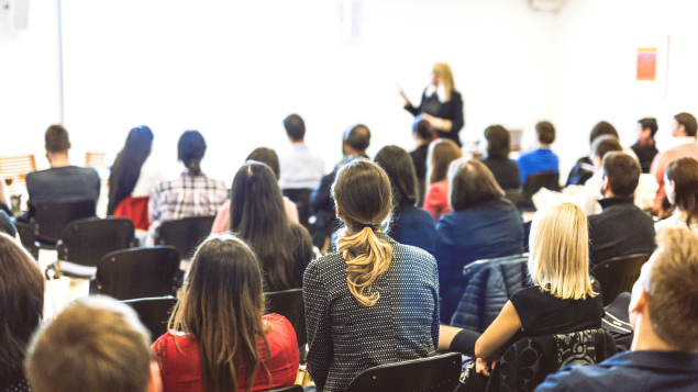 Woman standing in front of screen teaching class