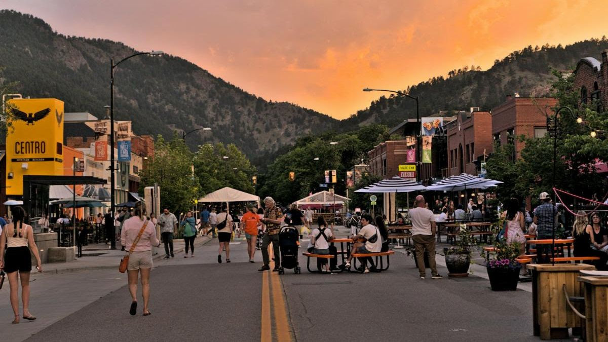 View of downtown Boulder with mountains and sunset in the background