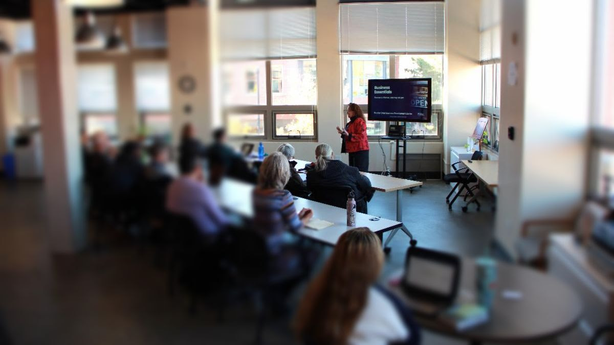 Woman standing in front of screen teaching class