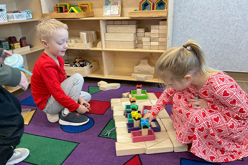 two kids playing with building blocks