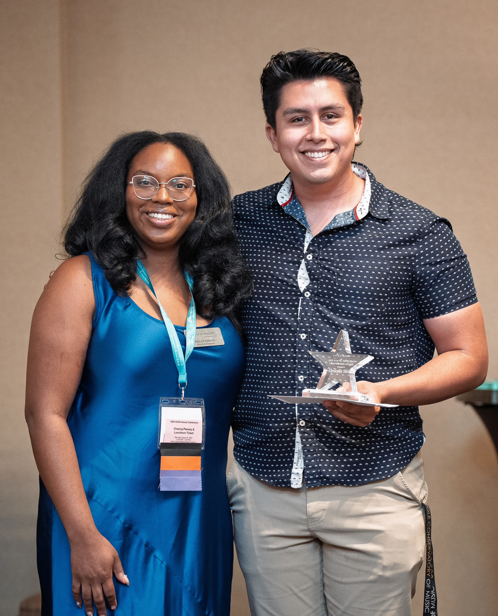 ACSO Board Member Akilah Morgan presents the 2025 Young Musician Leadership Award to Christopher Sterling,