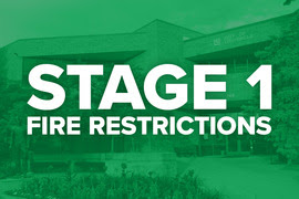 Green-tinted image of Louisville City Hall overlaid with the words Stage 1 Fire Restrictions