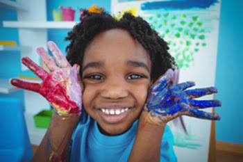 little kid with paint on his hands