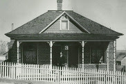 Historical black-and-white photo of a man in front of a home in Louisville’s Capitol Hill neighborhood