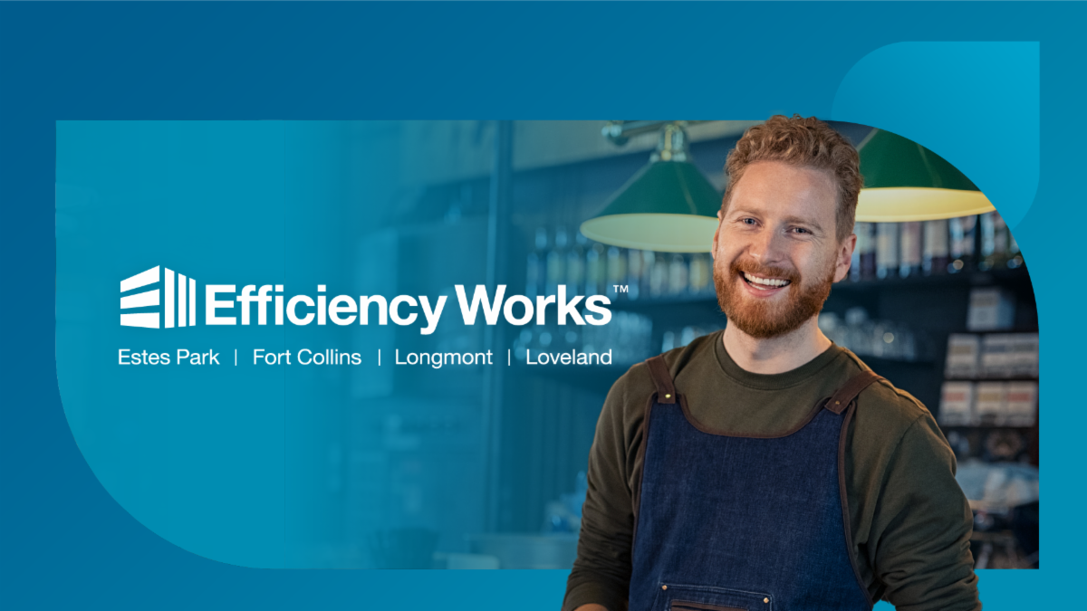 A business owner in an apron smiles at the camera. The Efficiency Works logo is also shown.