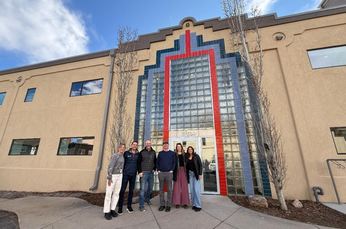 PACE Advisors stand in front of the KGNU building in Boulder 