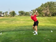 teen golfing on tee box
