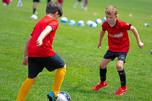 Two kids playing soccer
