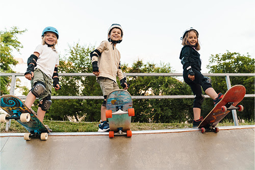 Three Kids Skateboarding