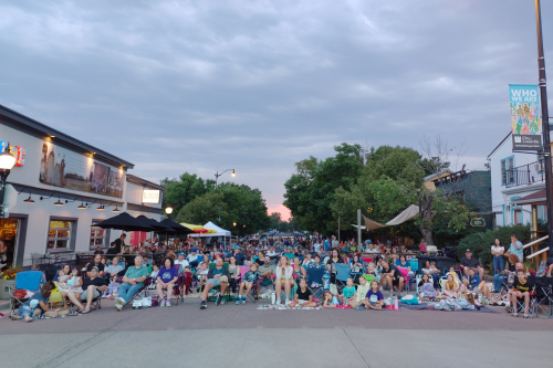People watching movie on main street