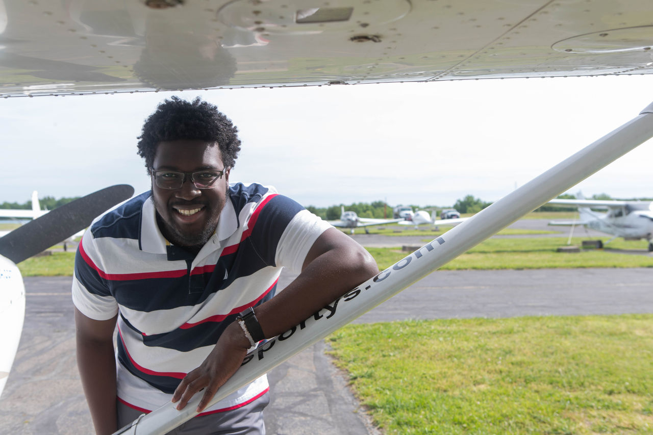 UC Clermont aviation student Glenn Adusei-Poku poses with airplane. 