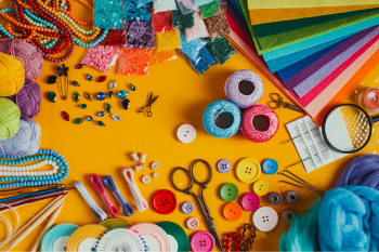 Various craft supplies against a yellowish-orange background