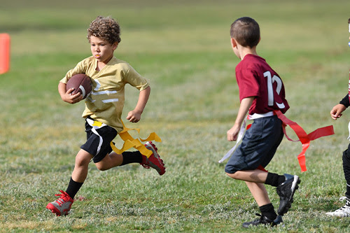 kid playing Flag Football