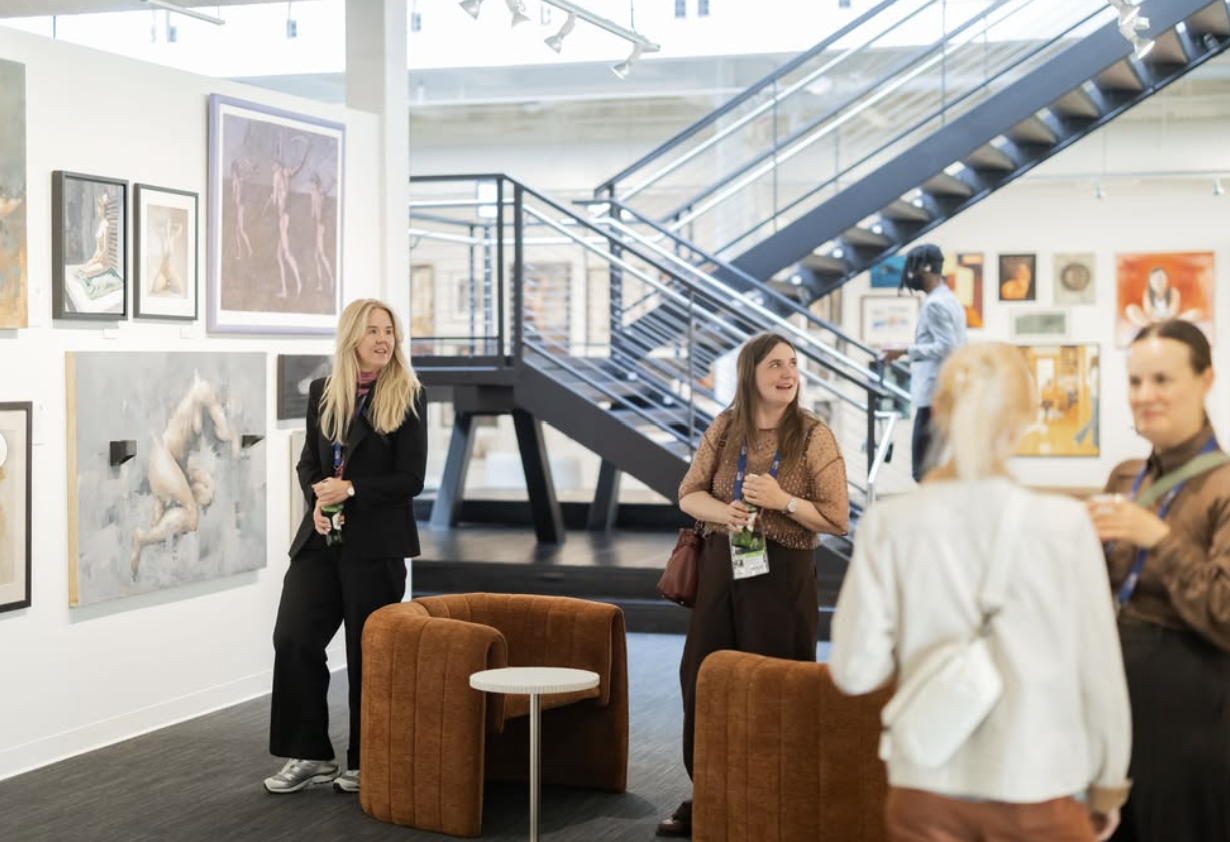 Guests gathering among the artwork at ArtLove Salon