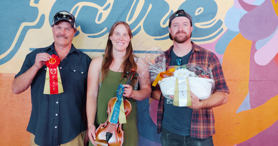 Three winners of 2025 Fiddle Contest holding their prizes