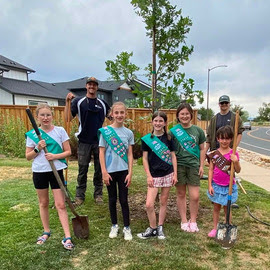 Girl Scout troup planting a tree