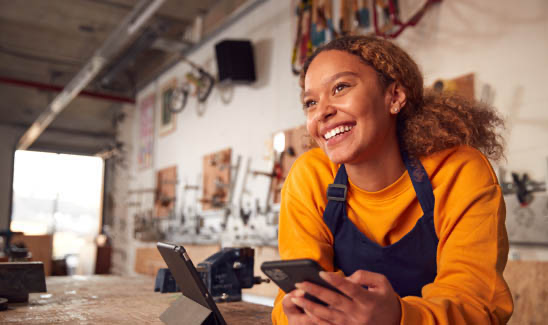 Happy small business owner standing in her shop.