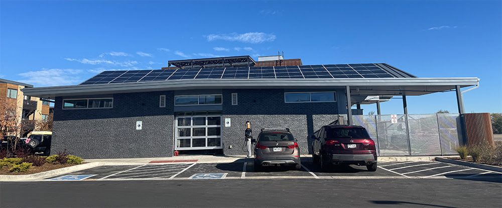A building is showing with a large solar array on the roof.