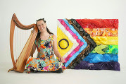 Musician Alex Bernat with harp and Intersex-Inclusive Progress Pride Flag