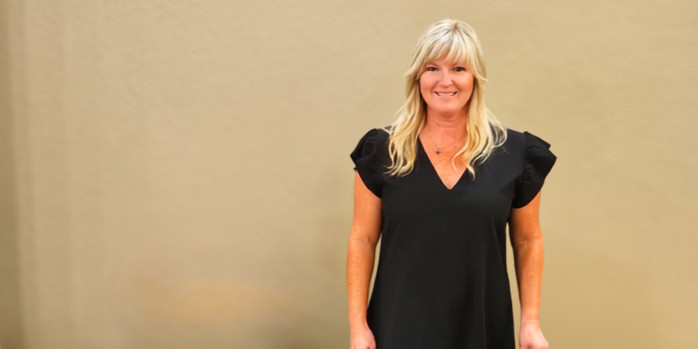 Woman standing in front of wall.