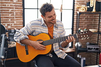 Photo of young male playing the guitar