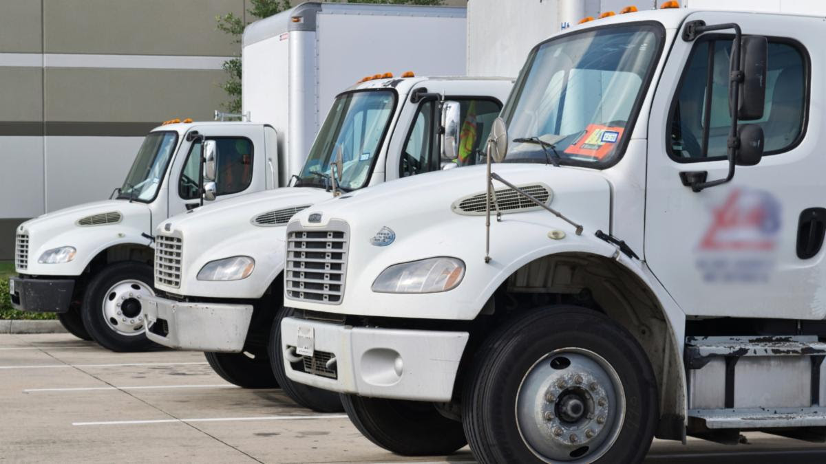 Commercial trucks parked in a row.