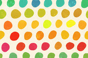 Irregular dots of different colors of paint atop an off-white surface