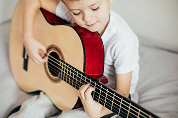 Young boy holding a guitar