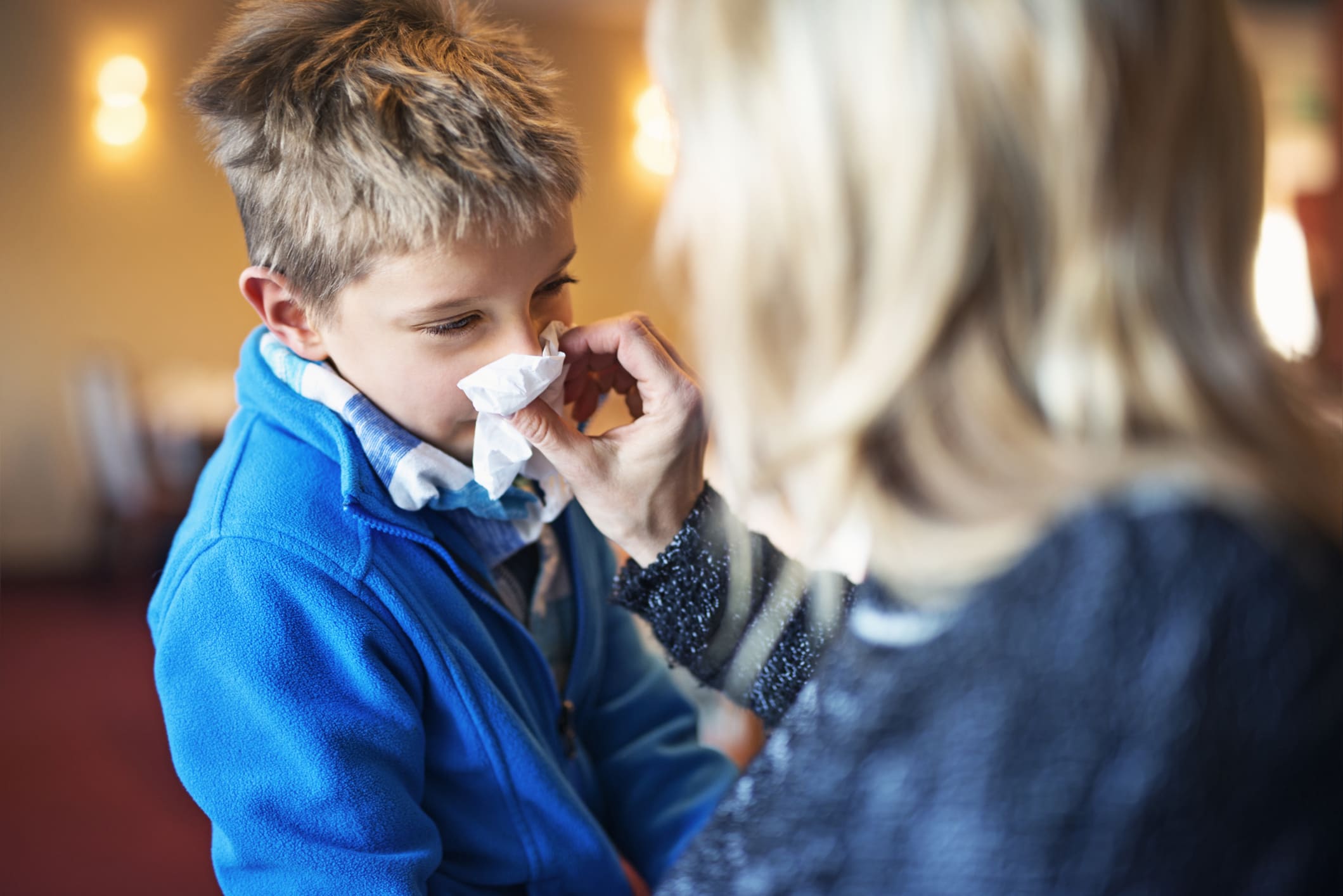 Mom wiping childs nose