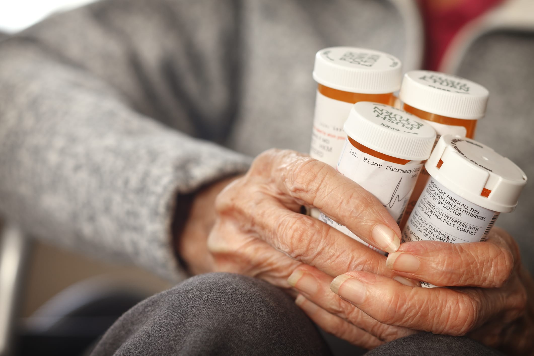 Elderly woman and handful of medication