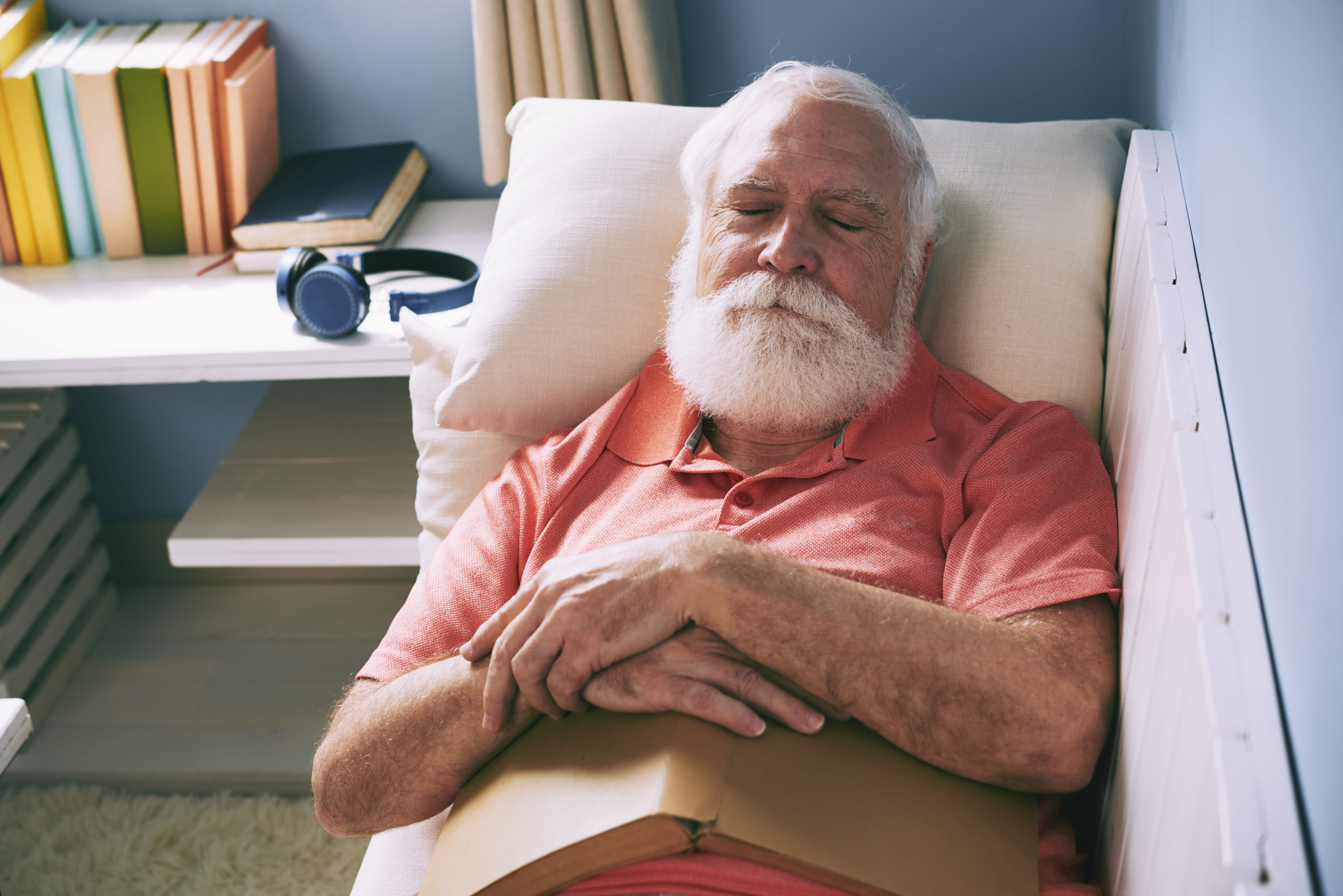 Senior asleep with book