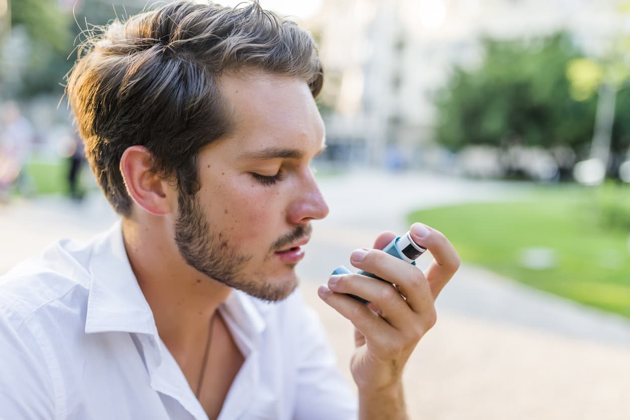 Young man using inhailer